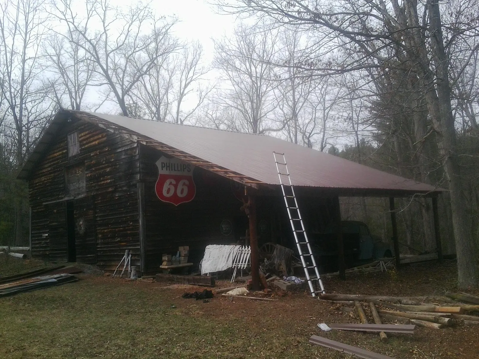 New metal roof on an open sided timber barn with a vintage sign in Jefferson